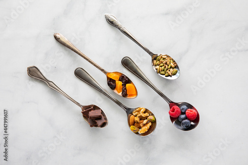 Top down view of fresh healthy ingredients in various vintage spoons.
