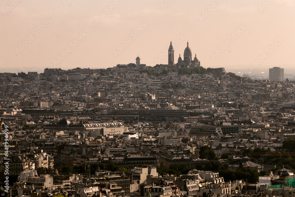 aerial view of the city of paris against the background of the church of the sacred heart in the afternoon