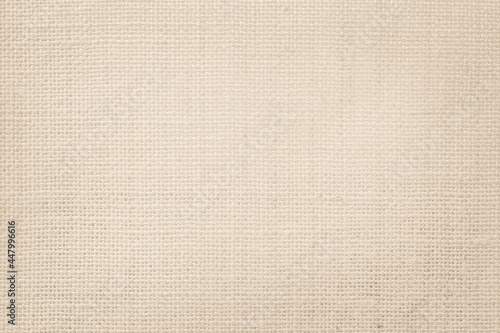 Jute hessian sackcloth canvas woven texture pattern background in light beige cream brown color blank empty