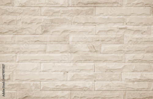 Empty background of wide cream brick wall texture. Beige old brown brick wall concrete or stone textured.