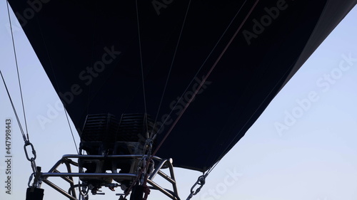 Pilot Adjusting The Flame On A Hot Air Balloon. Hot Air Balloon Inflating. Blowing Up Hot Air Balloons. Close Up Of Hot Air Balloons Ready To Take Off. Flame rising and inflating hot air balloon.