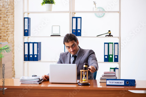 Young male lawyer sitting in the office