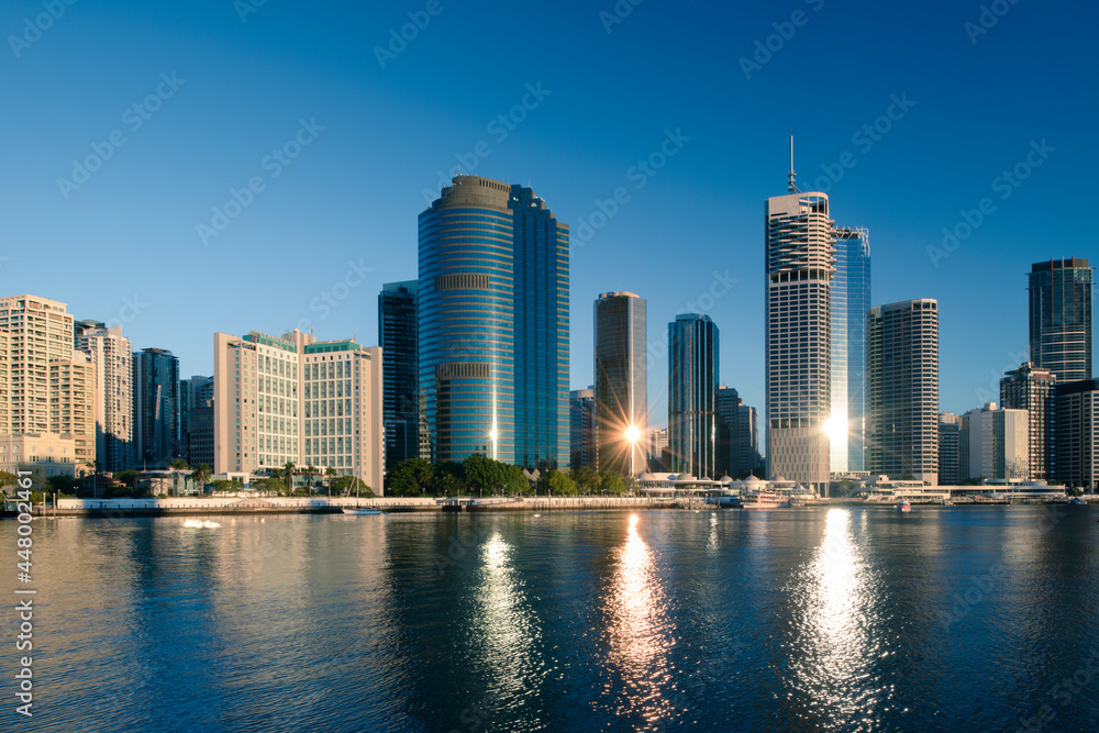 View of Brisbane city buildings and river seen in early morning light. Brisbane is the state capital of Queensland, Australia.