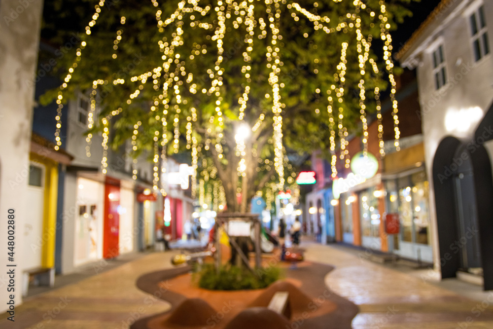 Fototapeta premium abstract blur image of night festival with a street walk and led light on tree bokeh for background