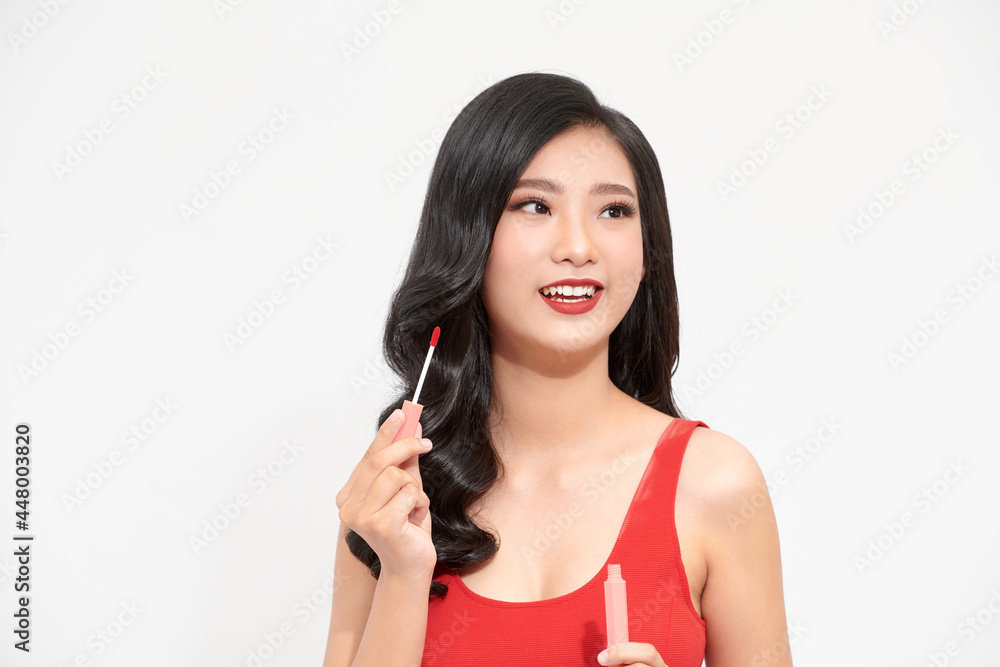 beautiful young woman doing makeup using a lip gloss beautiful young woman doing makeup using a lip gloss