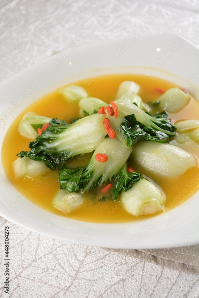 stir fried small cabbage with Chinese herbal in yellow chicken stock soup in white background asian halal vegan menu stir fried small cabbage with Chinese herbal in yellow chicken stock soup in white background asian halal vegan menu