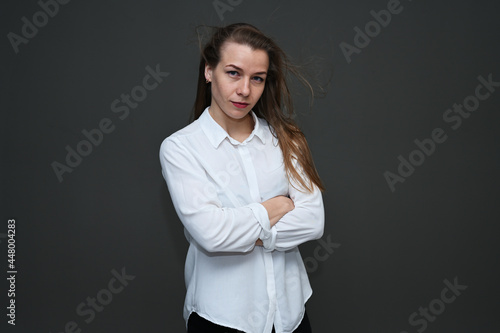 High resolution photo young serious woman in white blouse