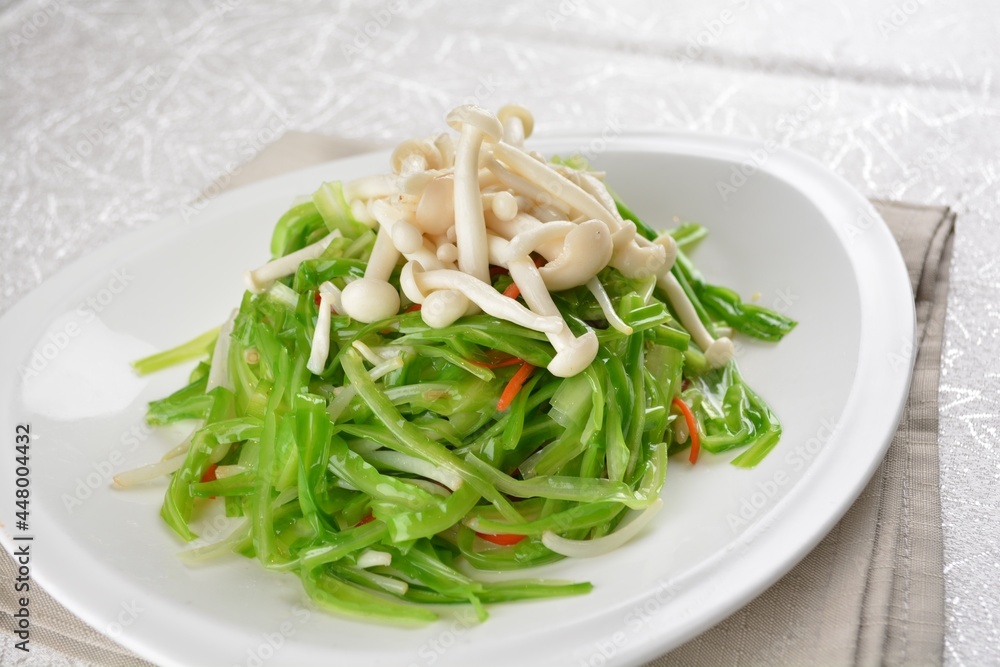 stir fried dragon vegetable with white mushroom vegetarian in soy sauce in white background asian halal vegan menu