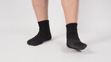 Asian leg and foot wear black sock on white background. isolated