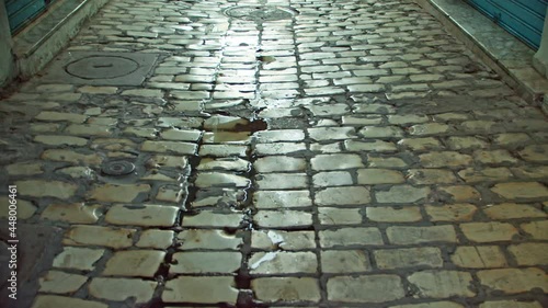 the cobblestones of the old city polished to a glitter. a bright white cobblestone walking road in the historical center of the city. the pavement of the southern city worn by the feet of tourists