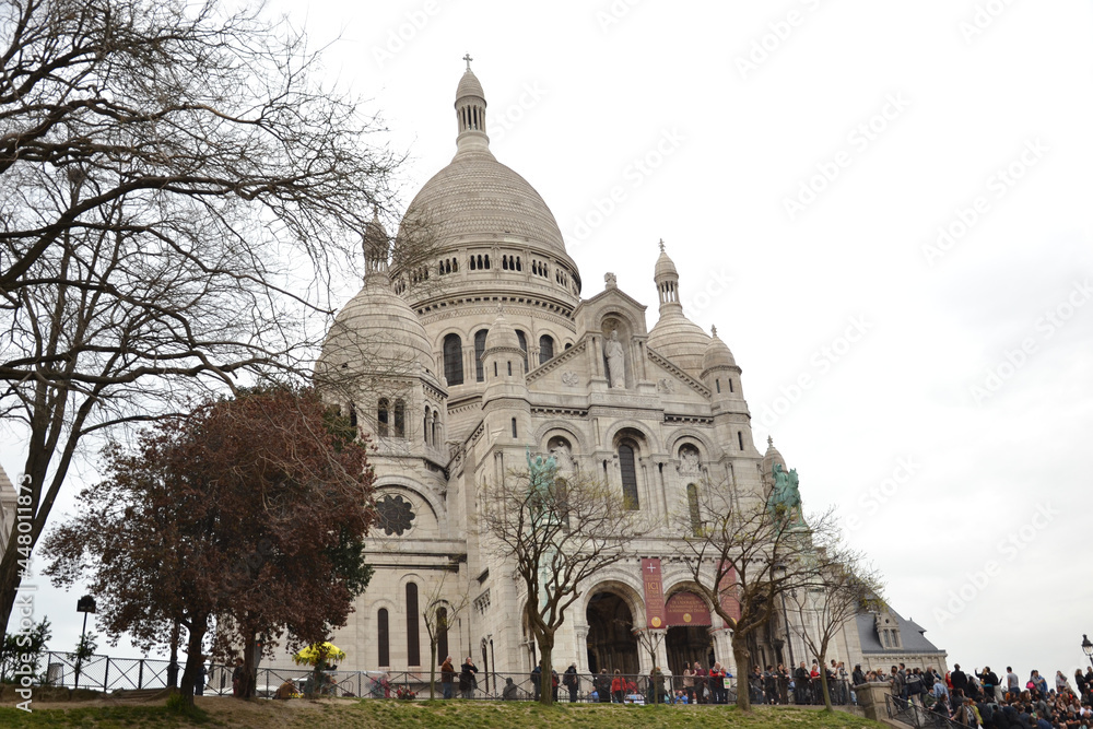 Paris, France - March 29th 2014 : Focus on the famous basilica Sacré-Coeur of Paris, in Montmartre. Paris, France - March 29th 2014 : Focus on the famous basilica Sacré-Coeur of Paris, in Montmartre.