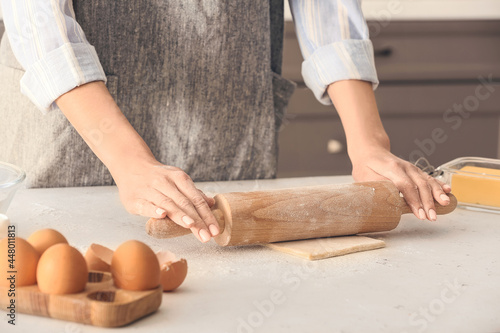 Woman rolling out dough on kitchen table © Pixel-Shot