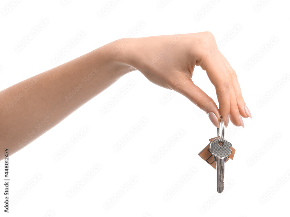 Female hand and key from house on white background Female hand and key from house on white background
