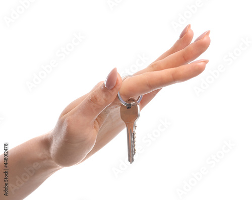 Female hand and key from house on white background