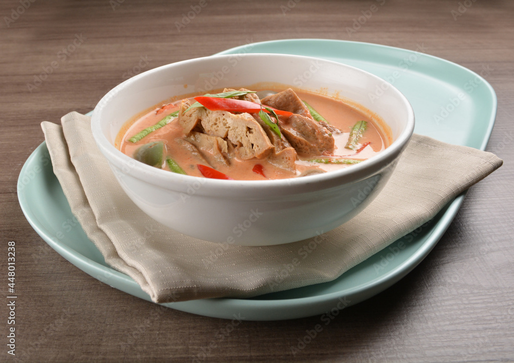 thai spicy chili red curry hot soup with vegetarian meat in bowl blue plate on wood background asian halal vegan menu thai spicy chili red curry hot soup with vegetarian meat in bowl blue plate on wood background asian halal vegan menu
