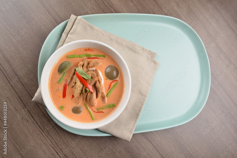 thai spicy chili red curry hot soup with vegetarian meat in bowl blue plate on wood background asian halal vegan menu thai spicy chili red curry hot soup with vegetarian meat in bowl blue plate on wood background asian halal vegan menu