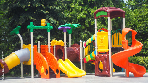 Colorful playground equipment in garden
 photo