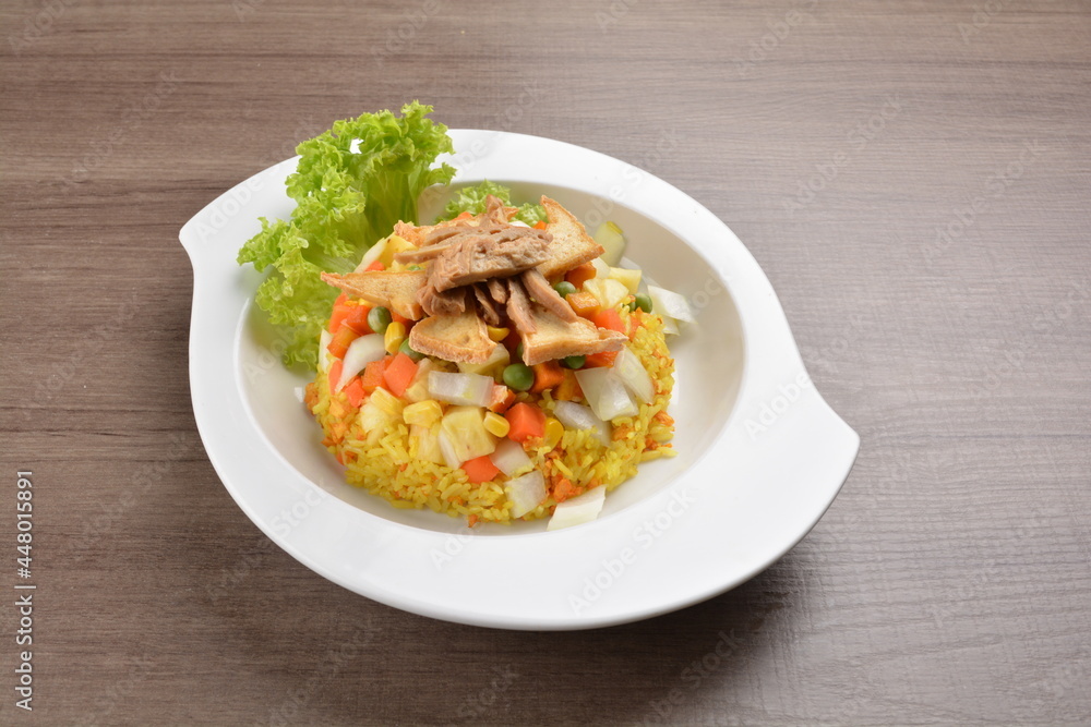 vegetarian nasi goreng fried rice with pineapple, vegetables meat in spicy chilli sambal sauce on wood background asian halal vegan menu vegetarian nasi goreng fried rice with pineapple, vegetables meat in spicy chilli sambal sauce on wood background asian halal vegan menu