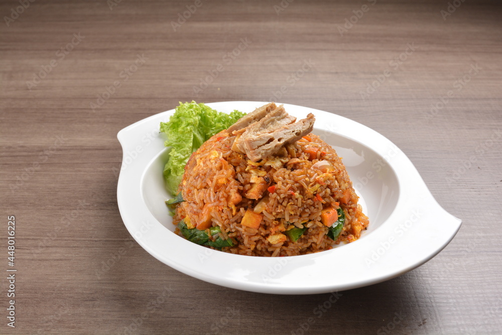 vegetarian nasi goreng fried rice with pineapple, vegetables meat in spicy chilli sambal sauce on wood background asian halal vegan menu vegetarian nasi goreng fried rice with pineapple, vegetables meat in spicy chilli sambal sauce on wood background asian halal vegan menu