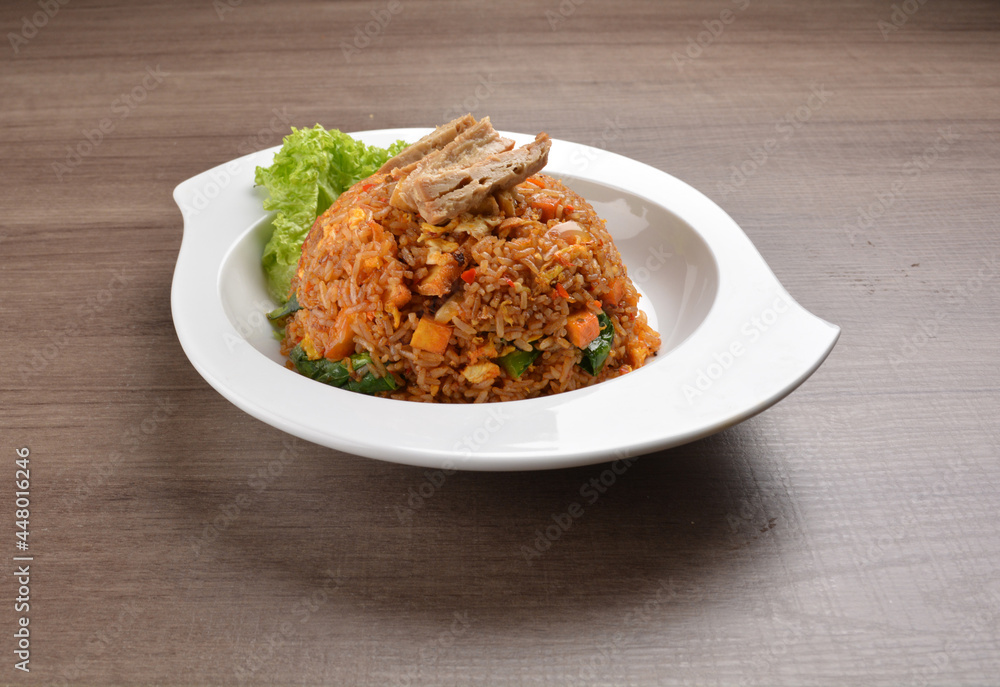 vegetarian nasi goreng fried rice with pineapple, vegetables meat in spicy chilli sambal sauce on wood background asian halal vegan menu vegetarian nasi goreng fried rice with pineapple, vegetables meat in spicy chilli sambal sauce on wood background asian halal vegan menu
