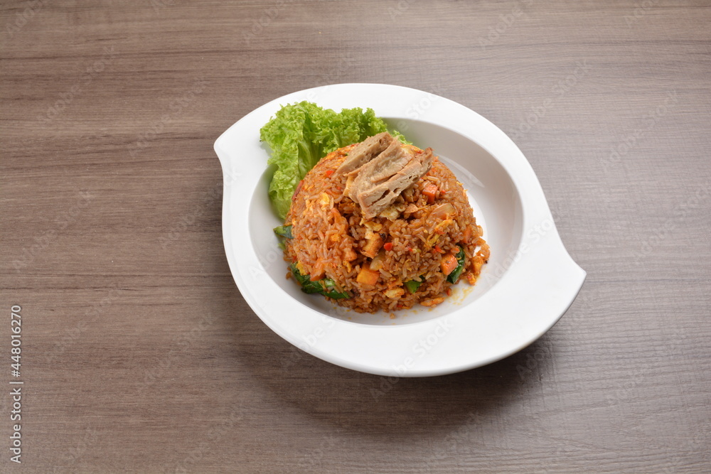 vegetarian nasi goreng fried rice with pineapple, vegetables meat in spicy chilli sambal sauce on wood background asian halal vegan menu vegetarian nasi goreng fried rice with pineapple, vegetables meat in spicy chilli sambal sauce on wood background asian halal vegan menu