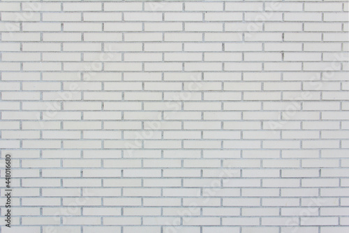 Wall of medium sized lined white bricks. Texture. Background.