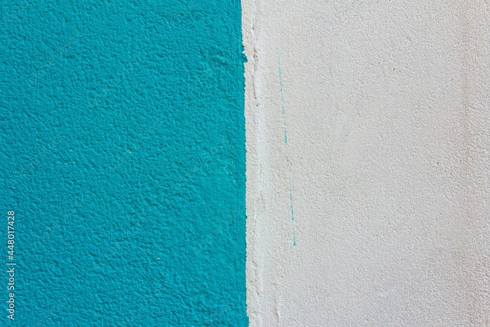 Fototapeta premium Blue wall texture with grain and white paint. Background.