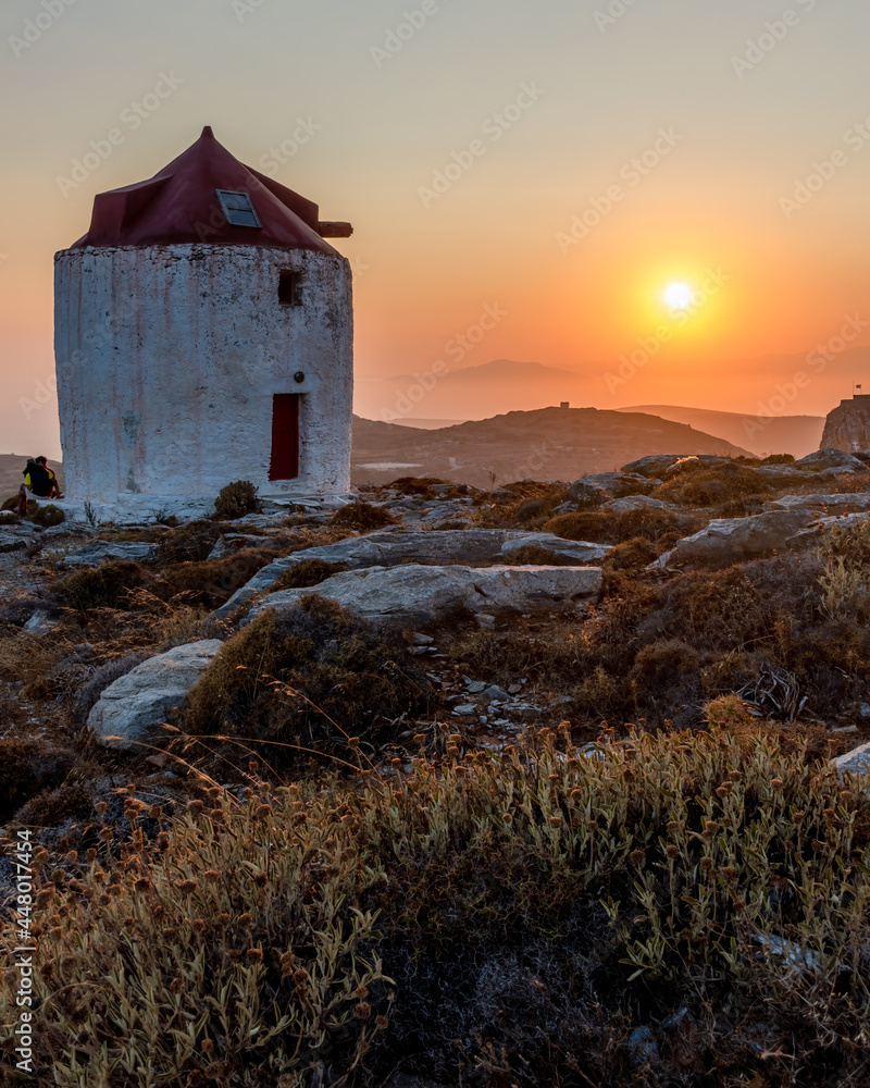 Fototapeta premium scenic golden hour view of a traditional wind mill in Chora Amorgos Greece