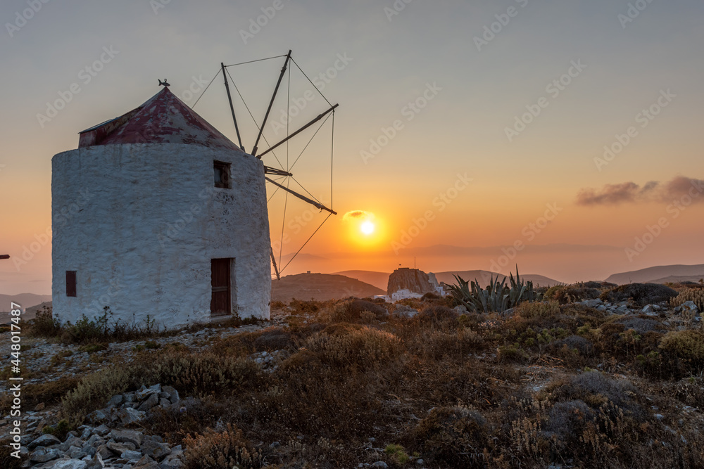 scenic golden hour view of a traditional wind mill in Chora Amorgos  Greece