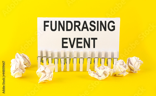 white paper on the yellow background with text FUNDRASING EVENT photo