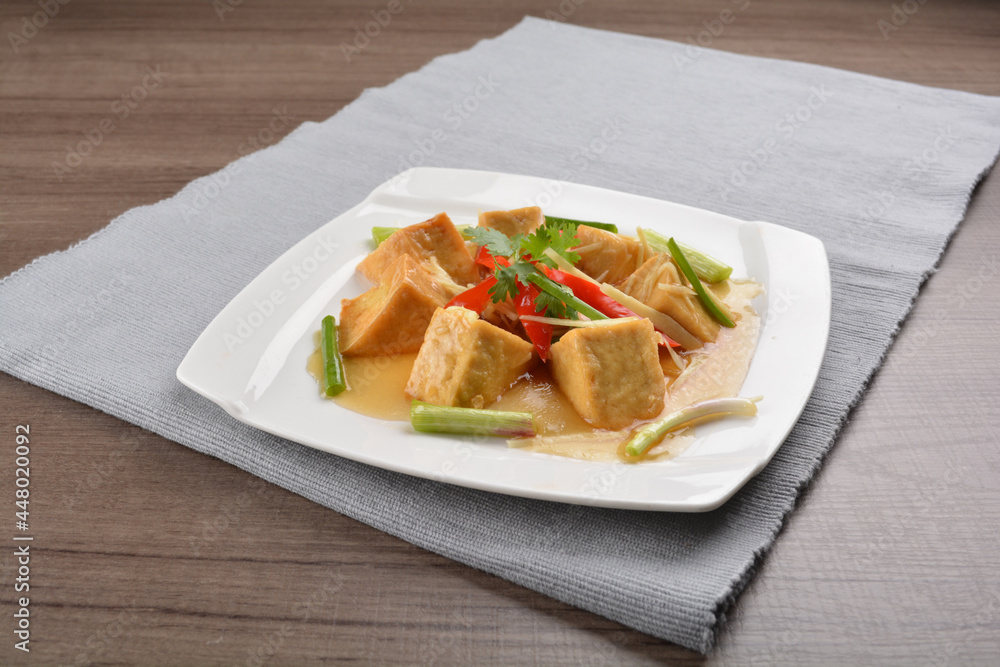 deep fried bean curd tofu with soy sauce on wood background asian halal vegan menu