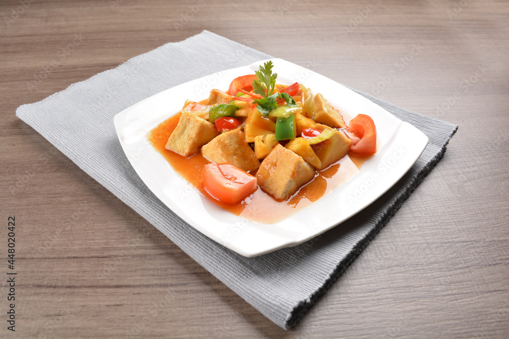 deep fried bean curd tofu with spicy sweet and sour chilli sauce on wood background asian halal vegan menu deep fried bean curd tofu with spicy sweet and sour chilli sauce on wood background asian halal vegan menu