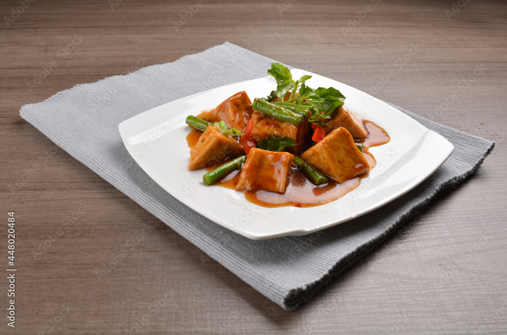 deep fried bean curd tofu with spicy sambal chilli sauce on wood background asian halal vegan menu deep fried bean curd tofu with spicy sambal chilli sauce on wood background asian halal vegan menu