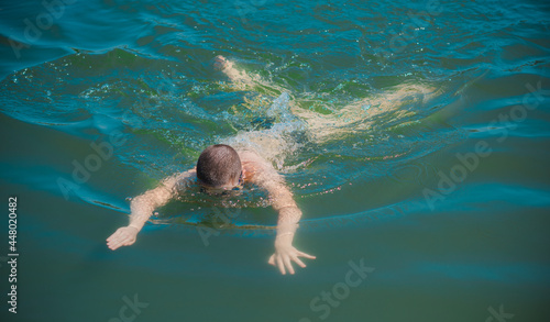 13 years Teenage boy swimming in lake, Children lifestyle. Enjoy the life