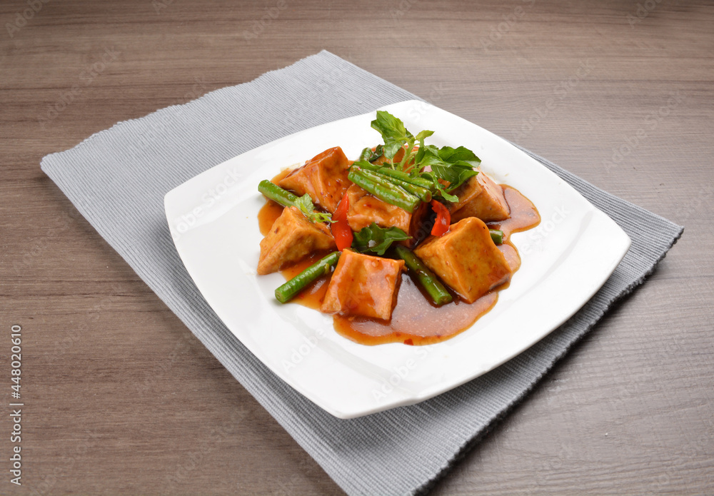 deep fried bean curd tofu with spicy sambal chilli sauce on wood background asian halal vegan menu deep fried bean curd tofu with spicy sambal chilli sauce on wood background asian halal vegan menu