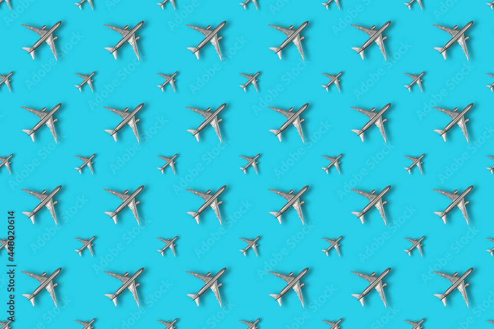 Soaring silver airplanes on a colored background. Repeating Chil