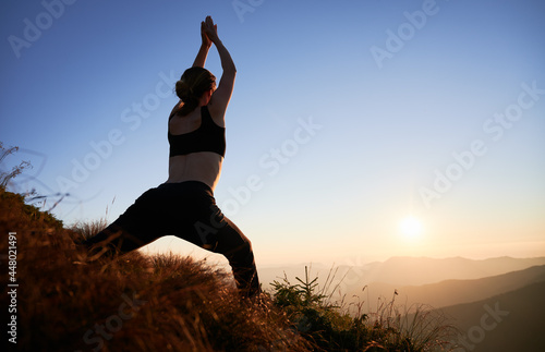 Fototapeta Naklejka Na Ścianę i Meble -  Woman doing exercise for stretching on fresh air at sunset. Concept of yoga time on nature.