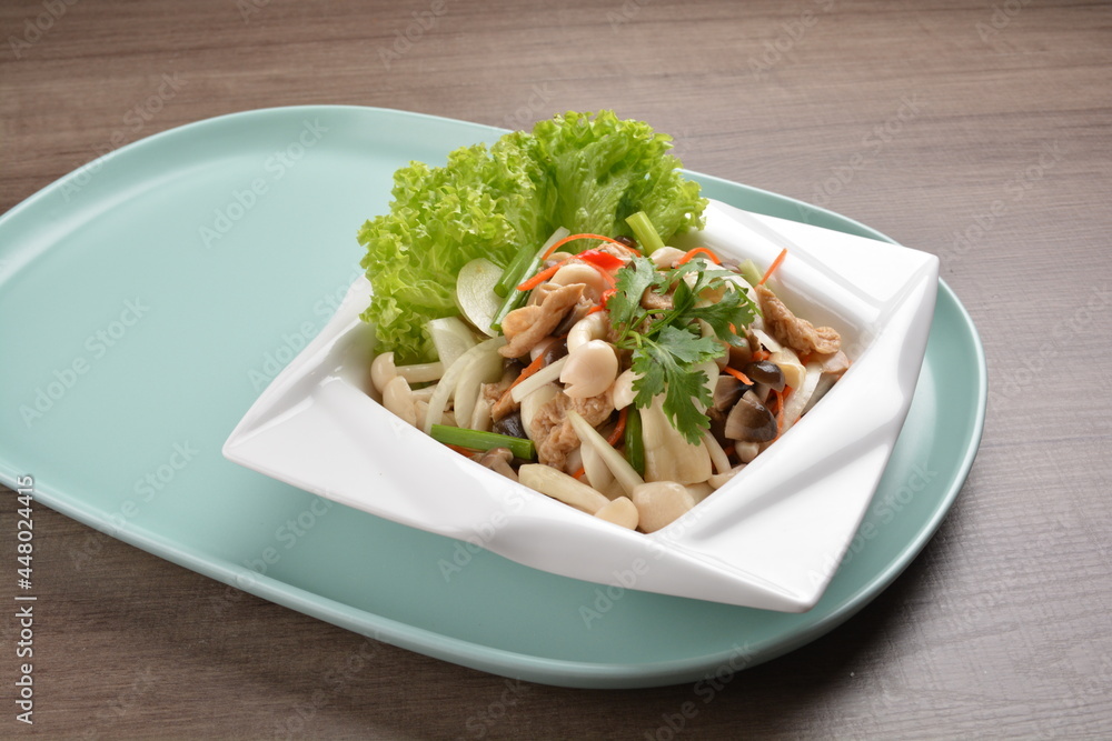 thai cold mushroom vegetable salad in spicy sour lime sauce on wood background asian halal vegan menu thai cold mushroom vegetable salad in spicy sour lime sauce on wood background asian halal vegan menu