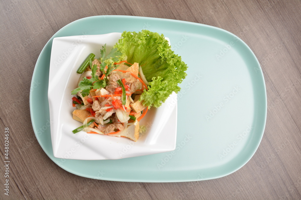 thai cold bean curd tofu vegetable salad in spicy sour lime sauce on wood background asian halal vegan menu thai cold bean curd tofu vegetable salad in spicy sour lime sauce on wood background asian halal vegan menu
