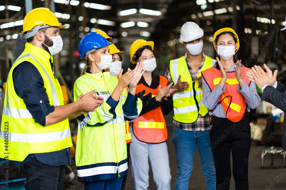 Group of diversity engineers Workers team wear protective face masks for safety in meeting. Success Worker man wearing face mask prevent covid-19 virus and protective hard hat. Group of diversity engineers Workers team wear protective face masks for safety in meeting. Success Worker man wearing face mask prevent covid-19 virus and protective hard hat.