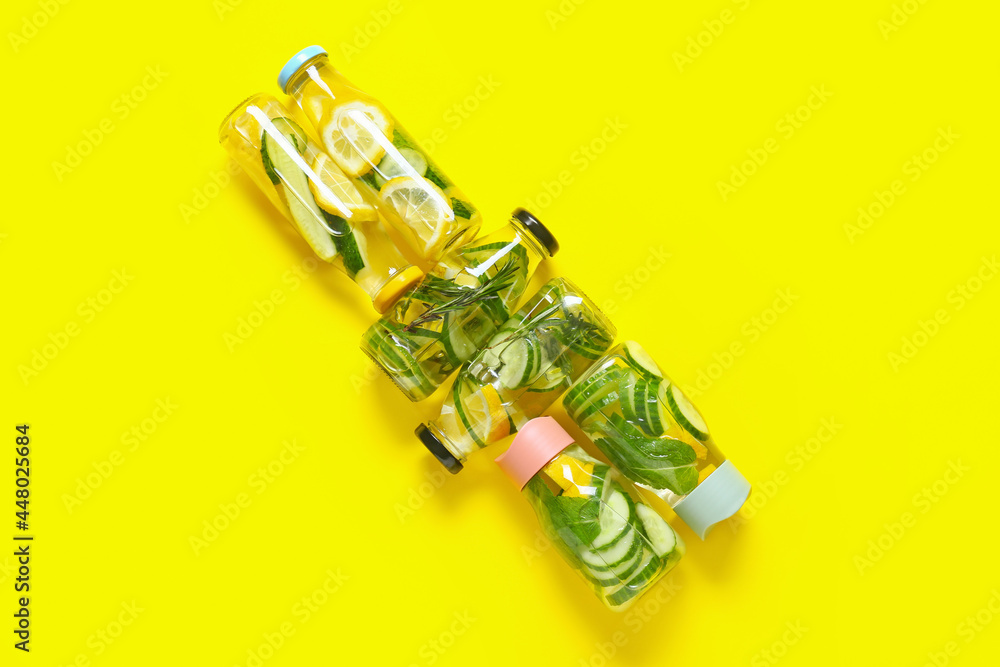 Bottles with cucumber lemonade on color background Bottles with cucumber lemonade on color background