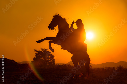 Cowboy silhouette riding a horse When the sunset looks beautiful
