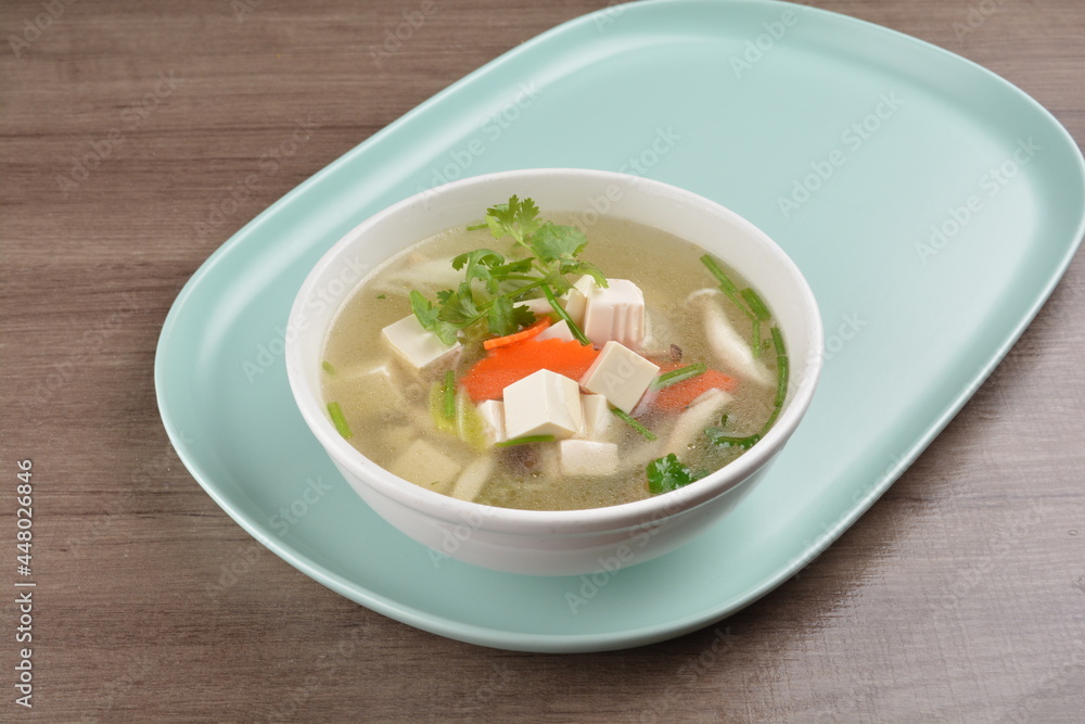 healthy white bean curd tofu and mixed vegetable hot soup on wood background asian halal vegan menu healthy white bean curd tofu and mixed vegetable hot soup on wood background asian halal vegan menu