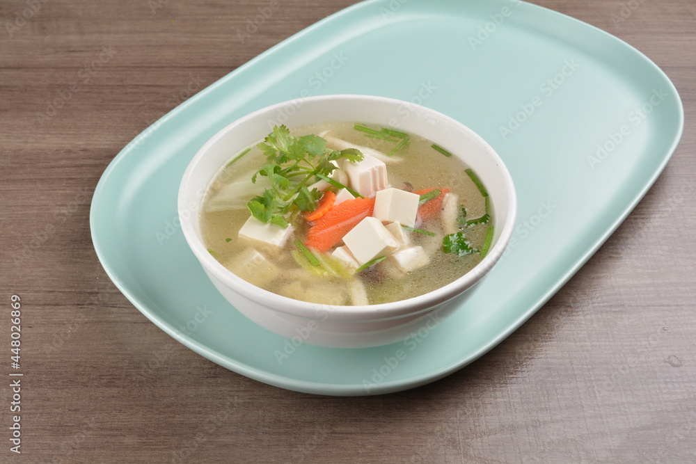 healthy white bean curd tofu and mixed vegetable hot soup on wood background asian halal vegan menu healthy white bean curd tofu and mixed vegetable hot soup on wood background asian halal vegan menu