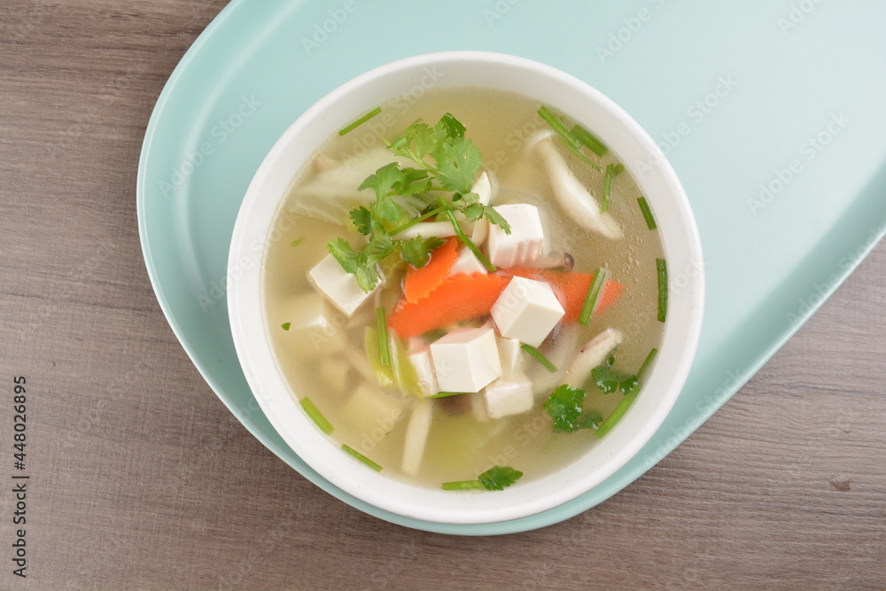 healthy white bean curd tofu and mixed vegetable hot soup on wood background asian halal vegan menu healthy white bean curd tofu and mixed vegetable hot soup on wood background asian halal vegan menu