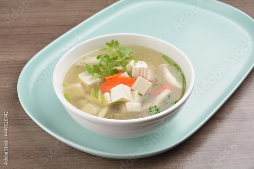 healthy white bean curd tofu and mixed vegetable hot soup on wood background asian halal vegan menu