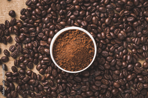 Coffee beans and powder with textured background stock image.