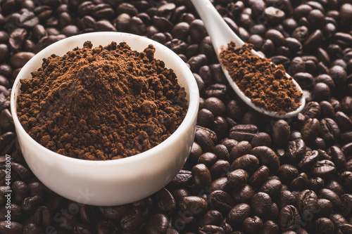 Coffee beans and powder with textured background stock image.