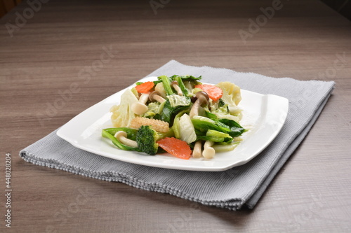 stir fried mixed vegetable and carrot in soy sauce on wood background asian halal vegan menu