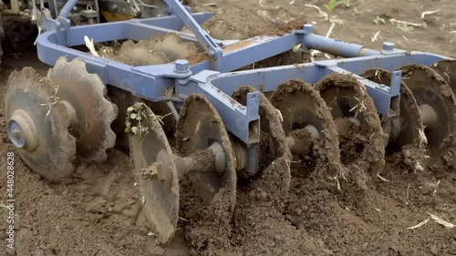 Wallpaper Mural Tractor with harrows prepares the agricultural land for planting crop. Agriculture harvesting preparing soil for  farming on field.
 Torontodigital.ca